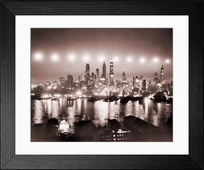 Framed Print : Lower Manhattan illuminated by ten photoflash cartridges of 50, 000, 000 candlepower each, dropped from a B-17 in June 1949 during a U.S.A.F. test of new photographic equipment