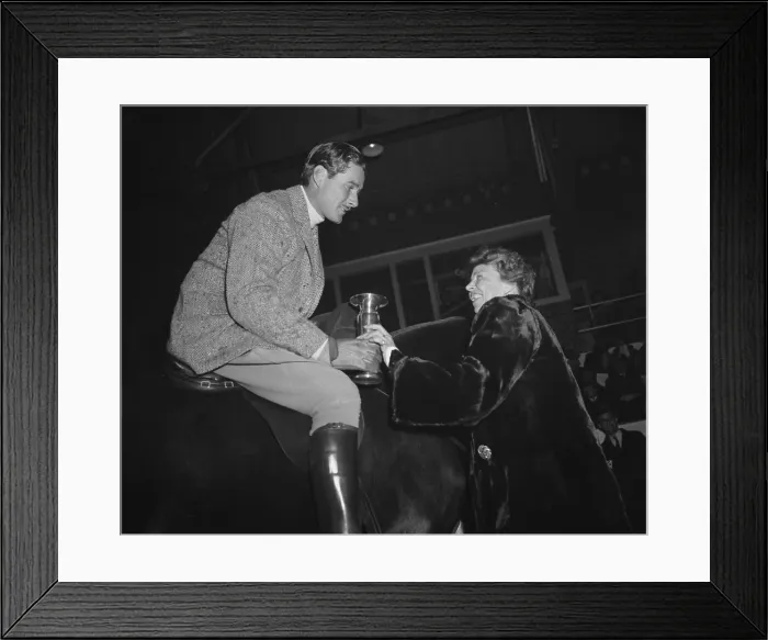 Framed Print : Eleanor Roosevelt presents a trophy to actor Errol Flynn, Jan. 1939. Flynn won the hack class trophy at the Fort Meyer President's Birthday Horse Show. (BSLOC_2013_7_11)