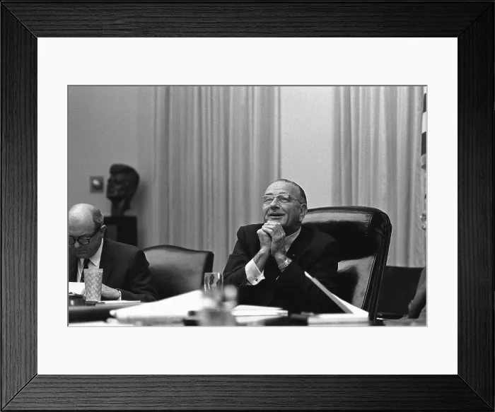 Framed Print : President Lyndon Johnson in with a beatific expression during a White House meeting. Beside him, Dean Rusk remains absorbed in this papers. June 16, 1967