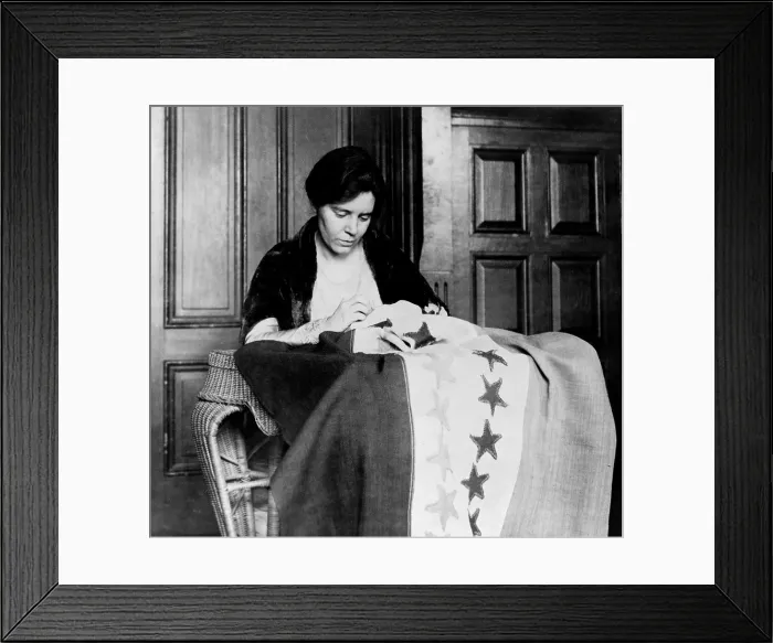 Framed Print : Alice Paul (1885-1977) sewing another star onto the 'Suffrage Flag, ' after another state ratified the 19th amendment, granting women the right to vote. Photo ca. 1919