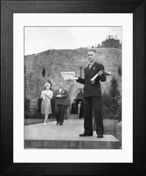 Framed Print : Teenager selling Father Coughlin's newspaper, Social Justice, July 1940. Behind him is the Shrine of the Little Flower Catholic Church, Detroit, Michigan
