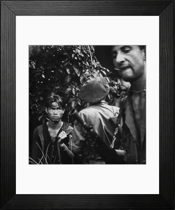 Framed Print : French Foreign Legionnaires with Viet Minh captive. Soldiers interrogate a suspected Viet Minh soldier found hiding in the jungle. Ca. 1954 Framed Print : French Foreign Legionnaires with Viet Minh captive. Soldiers interrogate a suspected Viet Minh soldier found hiding in the jungle. Ca. 1954