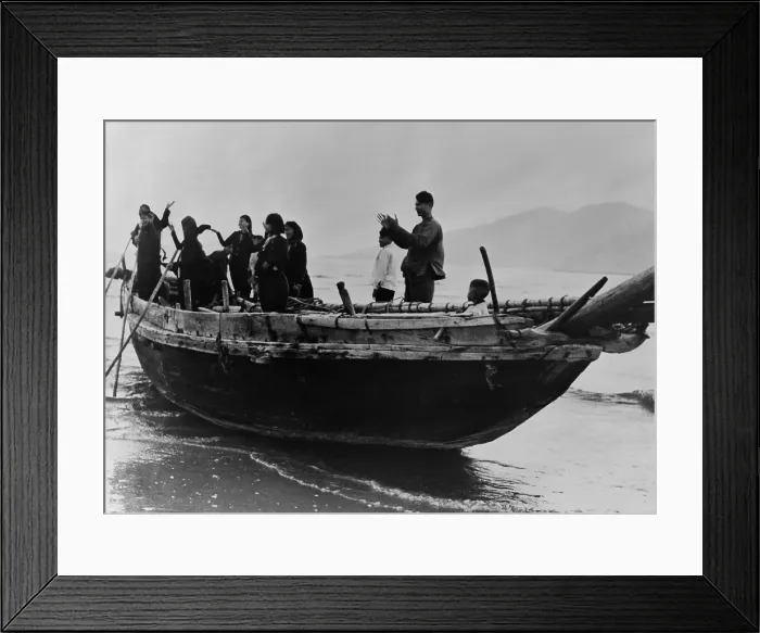 Framed Print : North Vietnamese refugees arrive at Da Nang, South Vietnam. Standing in a fishing boat, they applaud as they reach safe harbor in Tourane (Da Nang), South Vietnam. 1957 Framed Print : North Vietnamese refugees arrive at Da Nang, South Vietnam. Standing in a fishing boat, they applaud as they reach safe harbor in Tourane (Da Nang), South Vietnam. 1957