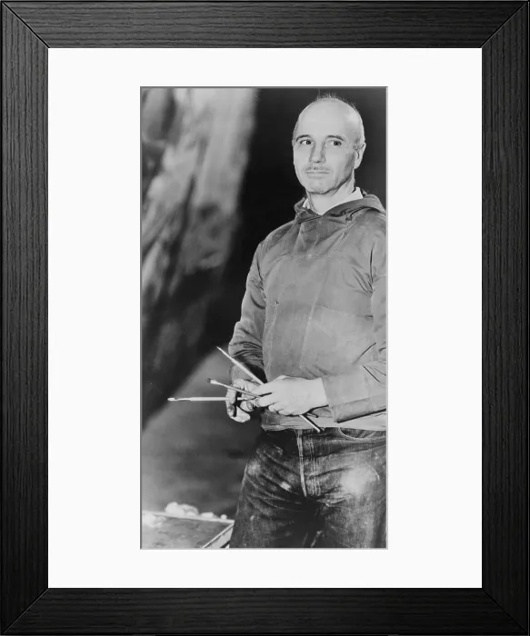 Framed Print : Rockwell Kent (1882-1971), American realist painter holding paint brushes, 1939