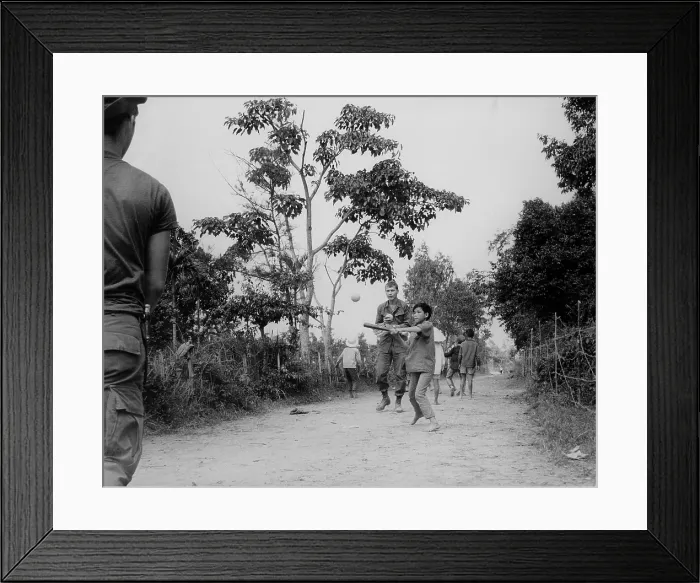 Framed Print : Vietnam Pacification operations. Soldiers of the 101st Airborne Division, join the children of Ap Uu Thoung hamlet, north of Hue, in a game of baseball. Jan. 15, 1970 Framed Print : Vietnam Pacification operations. Soldiers of the 101st Airborne Division, join the children of Ap Uu Thoung hamlet, north of Hue, in a game of baseball. Jan. 15, 1970