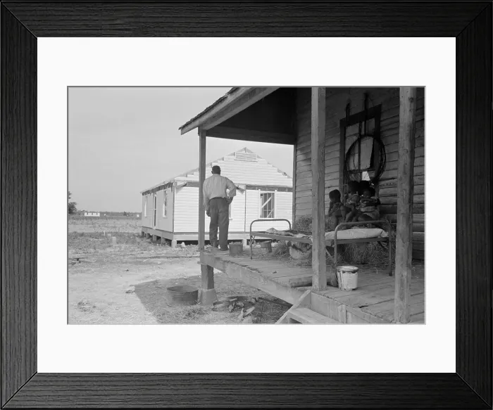 Framed Print : African American farm worker, looking at a new home from his shack, May 1938. At Southeast Missouri Farms, a New Deal Resettlement Administration project. (BSLOC_2013_7_53)