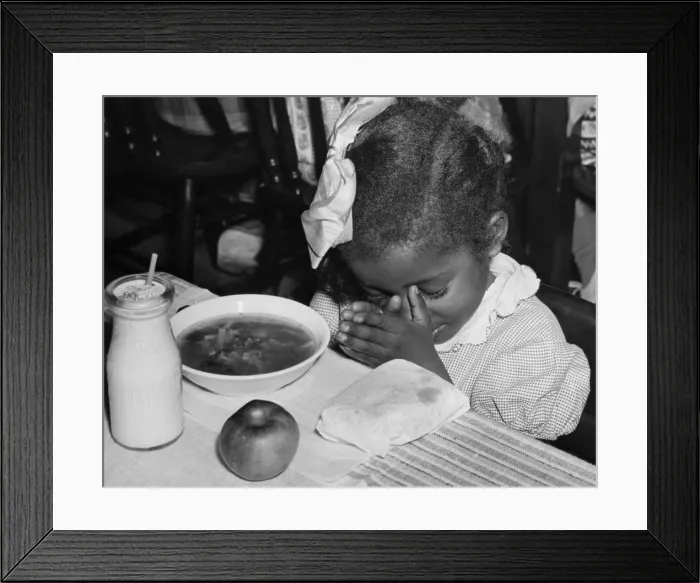 Framed Print : African American school girl saying grace. Her meal was subsidized by the Surplus Commodities, School Lunch Programs. Ca. 1937. (BSLOC_2013_7_56)