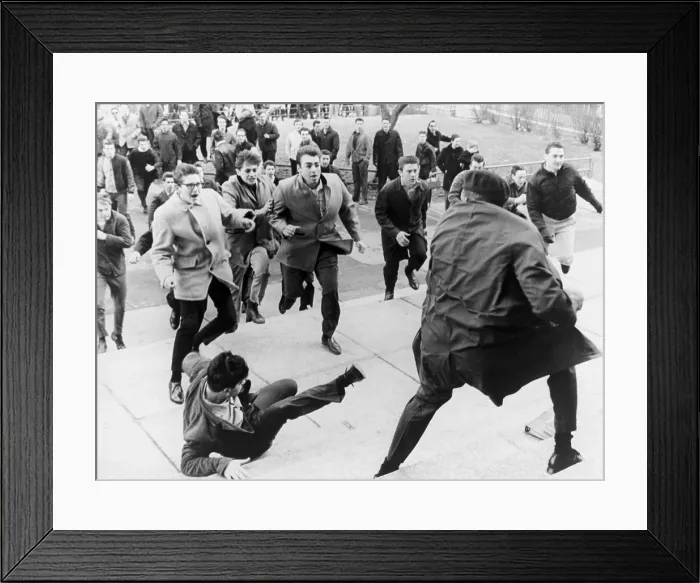 Framed Print : White students running toward an African American during period of racial violence at Collinwood High School in Cleveland, Ohio. March 1965