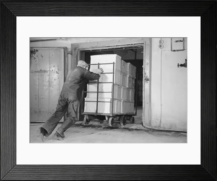 Framed Print : Worker pushes a heavy cart of packed eggs into a cold storage warehouse, Jersey City, New Jersey in April 1939 Framed Print : Worker pushes a heavy cart of packed eggs into a cold storage warehouse, Jersey City, New Jersey in April 1939