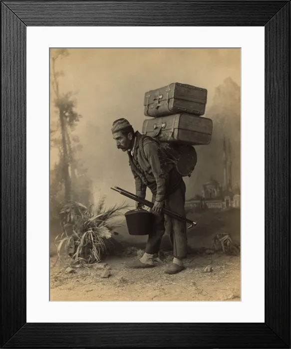 Framed Print : Turkish porter carrying luggage on his back. Studio portrait with painted backdrop of landscape with mosque, by Abdullah Freres, ca. 1890 Framed Print : Turkish porter carrying luggage on his back. Studio portrait with painted backdrop of landscape with mosque, by Abdullah Freres, ca. 1890
