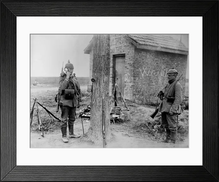 Framed Print : German soldier talking on telephone which is attached to a tree during WW1. 1914. (BSLOC_2012_4_132)