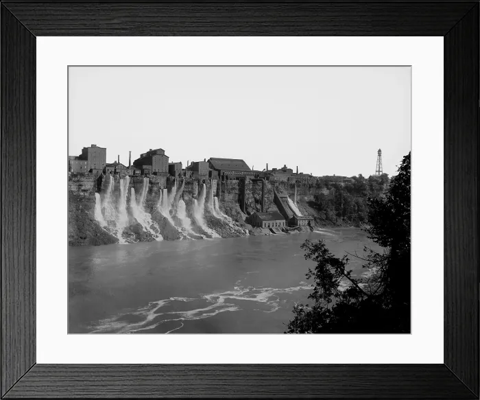 Framed Print : A cluster of factories built on and into the walls of the Niagara River Gorge. Water diverted from above the great Niagara Falls flows from the factories power generation plants Framed Print : A cluster of factories built on and into the walls of the Niagara River Gorge. Water diverted from above the great Niagara Falls flows from the factories power generation plants