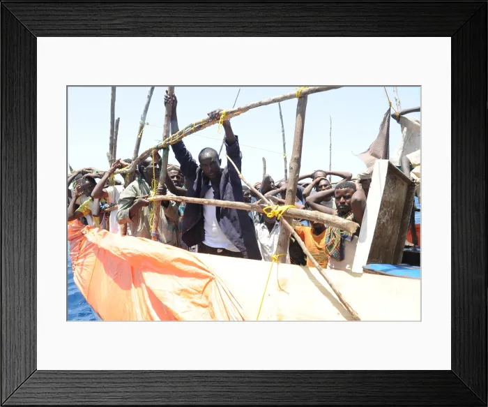 Framed Print : Suspected pirates in the Gulf of Aden under arrest await a search team from the USS Gettysburg part of a multinational counter-piracy task force