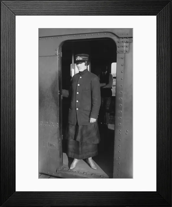 Framed Print : Uniformed woman Brooklyn Subway guard stands in the doorway of train car. Ca. 1910