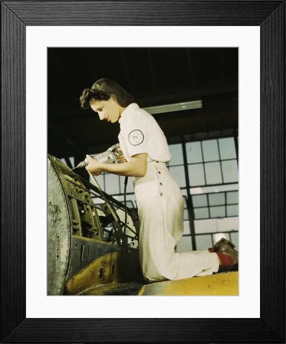 Framed Print : Defense worker riveting as part of her training to become a mechanic at the Naval Air Base, in Corpus Christi, Texas. August 1942