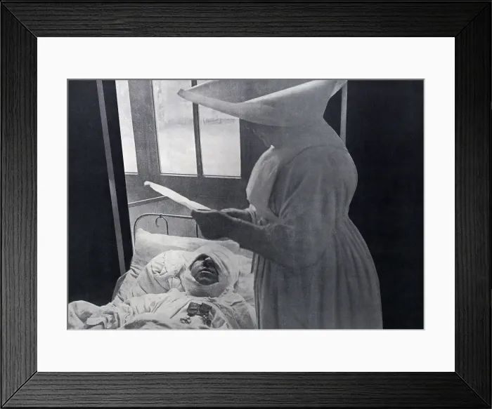 Framed Print : French nun attending a WW1 wounded soldier decorated in his hospital bed. 1916. He wears his two medals as well as a massive bandage for a head wound. (BSLOC_2012_4_63) Framed Print : French nun attending a WW1 wounded soldier decorated in his hospital bed. 1916. He wears his two medals as well as a massive bandage for a head wound. (BSLOC_2012_4_63)