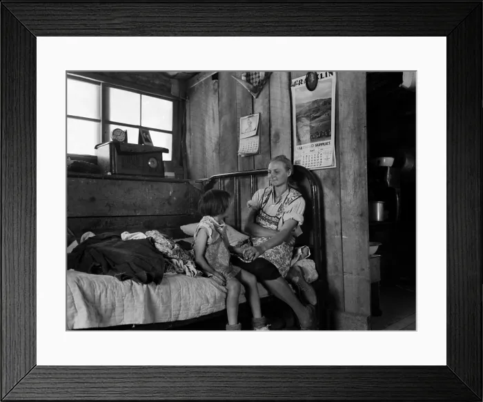 Framed Print : Listening to the radio. A mother smiles at her daughter as they listen to the radio in their dugout home Framed Print : Listening to the radio. A mother smiles at her daughter as they listen to the radio in their dugout home