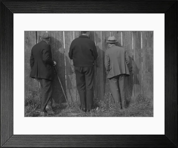 Framed Print : The backs of three men watching a football game through cracks in a fence. Star City, West Virginia. Oct. 1935 photo by Ben Shahn