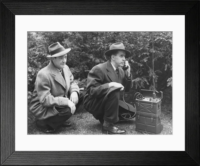 Framed Print : FBI agent with an huge portable phone during a kidnapping stakeout. Ca. 1940s