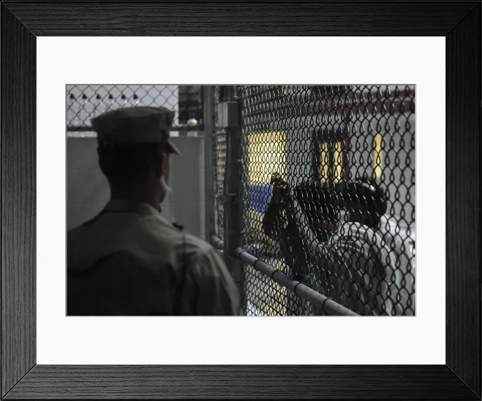 Framed Print : U.S. Sailor stands watch over a cell block at U.S Framed Print : U.S. Sailor stands watch over a cell block at U.S