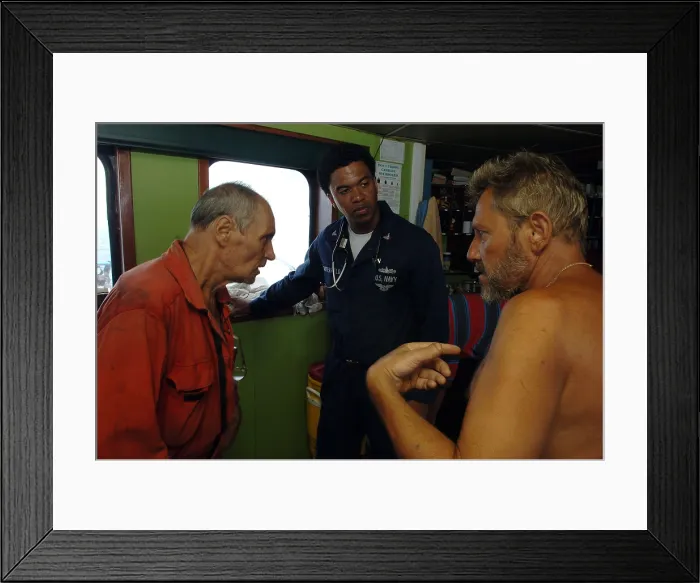 Framed Print : U.S. Navy Corpsman treats crew members from Belize-flagged Ukrainian ship FAINA after their release by Somali pirates following four months captivity. Feb