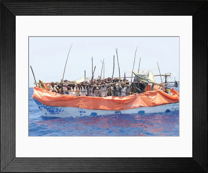 Framed Print : Primitive boat crowded with suspected pirates under arrest and awaiting a U.S. Navy boarding party in the Gulf of Aden Framed Print : Primitive boat crowded with suspected pirates under arrest and awaiting a U.S. Navy boarding party in the Gulf of Aden