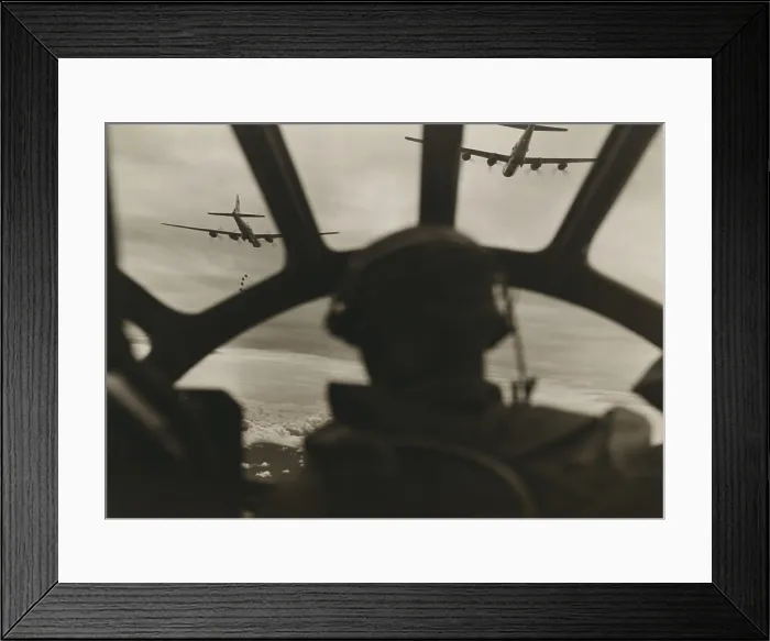 Framed Print : Two B-29 Super-fortresses drop bombs over Malaya as seen from the cockpit of a third bomber during a run over the important railway yards Framed Print : Two B-29 Super-fortresses drop bombs over Malaya as seen from the cockpit of a third bomber during a run over the important railway yards