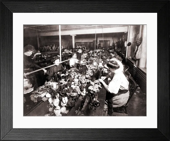 Framed Print : Women workers sewing teddy bears in an sweat shop assembly line. Women are engaged at the sewing machines, while men associated with the operation are in the background