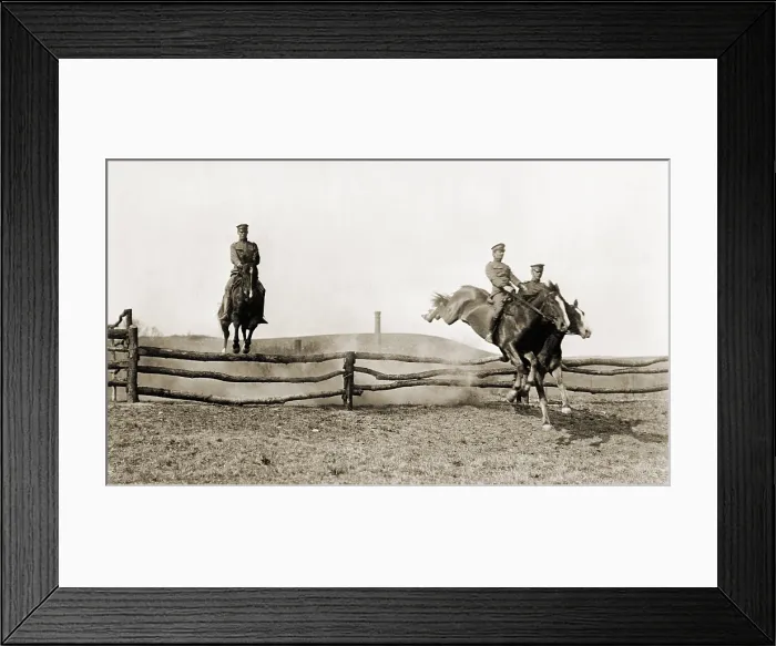 Framed Print : Three U.S. Army cavalrymen exhibit their horsemanship as they jump over barrier fences at a full gallop. Ca. 1915