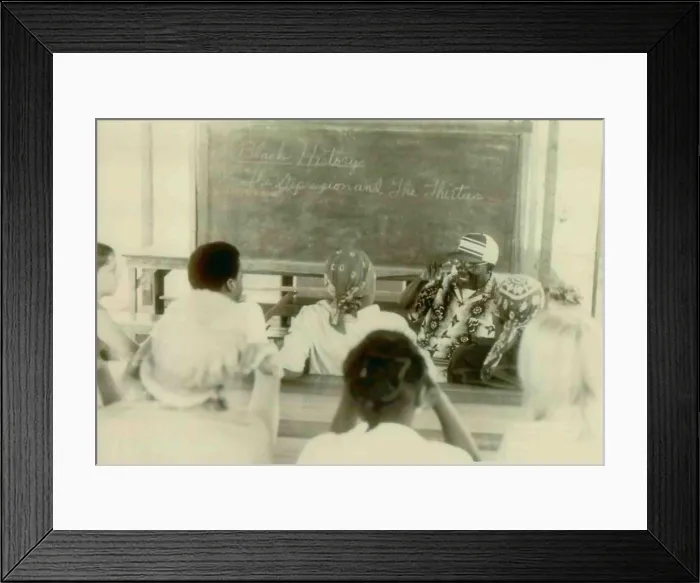 Framed Print : Henry Mercer teaching school. Written on the blackboard is Black History. The Depression and the Thirties. The People's Temple Agricultural Project Framed Print : Henry Mercer teaching school. Written on the blackboard is Black History. The Depression and the Thirties. The People's Temple Agricultural Project