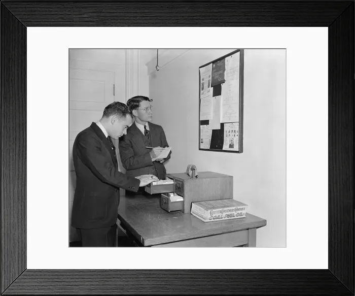 Framed Print : Secret Service agents checking over bulletin board getting the latest criminal news. October 1938