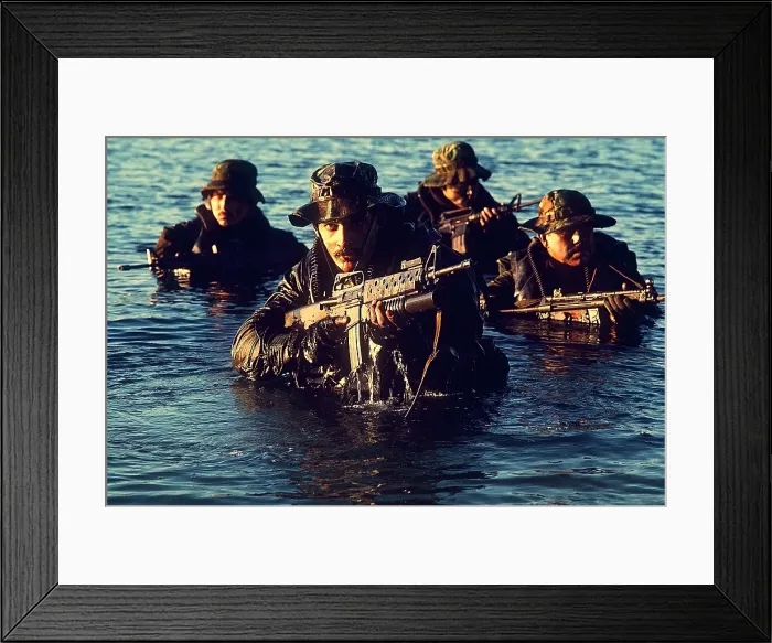 Framed Print : US Navy SEAL team emerges from water during warfare training. Foreground SEAL is armed with an M-16 rifle equipped with a grenade launcher. Dec. 1 1986. (BSLOC_2011_12_275)