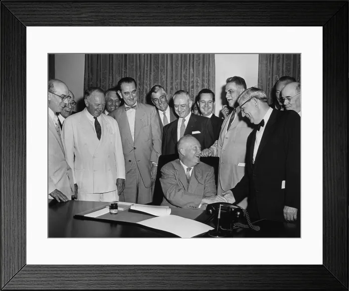 Framed Print : President Eisenhower signs a bill as Senate Majority Leader, Lyndon Johnson, and others look on. Johnson is fifth from left with the bow tie. June 1955