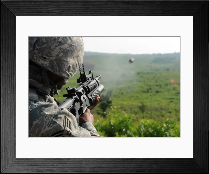 Framed Print : US soldier fires a practice round out of a M203 grenade launcher at Marine Corps Base Quantico Virginia. July 15 2010. (BSLOC_2011_12_306)