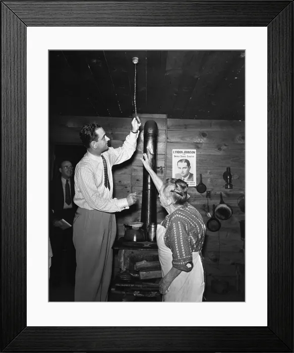 Framed Print : Congressman Lyndon Johnson examines Mrs. Mattie Malone's new electric light fixture in Carthage, Texas Framed Print : Congressman Lyndon Johnson examines Mrs. Mattie Malone's new electric light fixture in Carthage, Texas