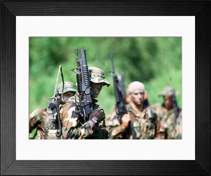 Framed Print : US Navy SEALs in warfare training. Foreground SEAL carries a field radio and a Colt Commando assault rifle equipped with an M-203 grenade launcher. Aug. 1 1987 Framed Print : US Navy SEALs in warfare training. Foreground SEAL carries a field radio and a Colt Commando assault rifle equipped with an M-203 grenade launcher. Aug. 1 1987