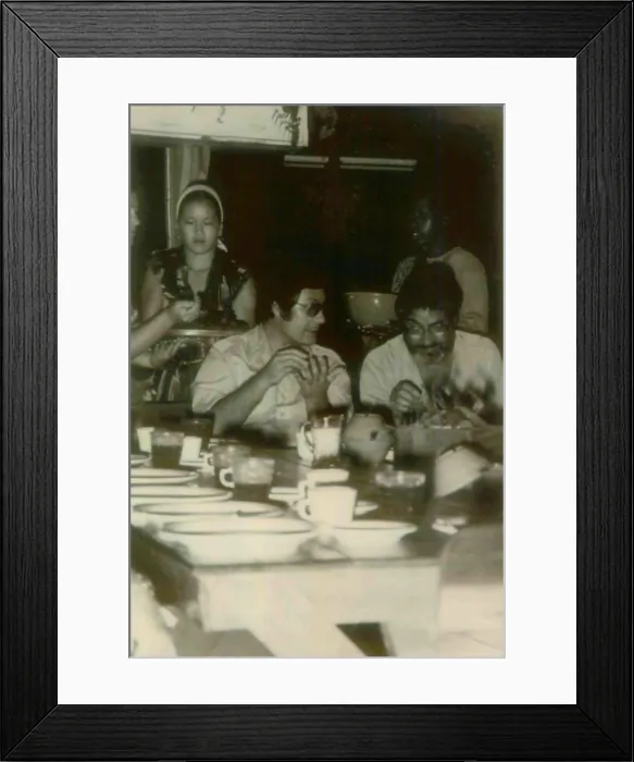 Framed Print : Jim Jones and a guest in Jonestown. At left is Kim Tschetter serving dinner. People's Temple Agricultural Project. Jonestown, Guyana. Nov. 1978
