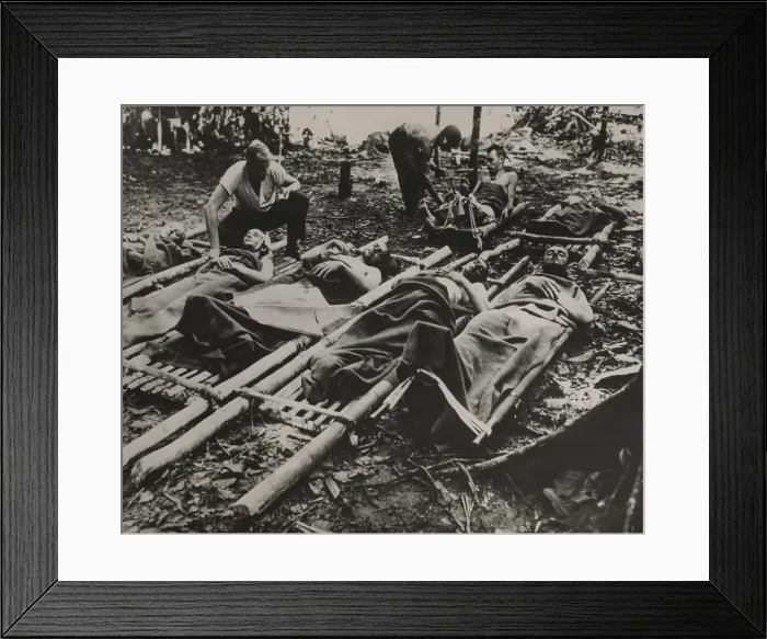 Framed Print : Wounded American soldiers waiting for treatment and evacuation in crude stretchers in New Guinea during World War II. 1943 Framed Print : Wounded American soldiers waiting for treatment and evacuation in crude stretchers in New Guinea during World War II. 1943