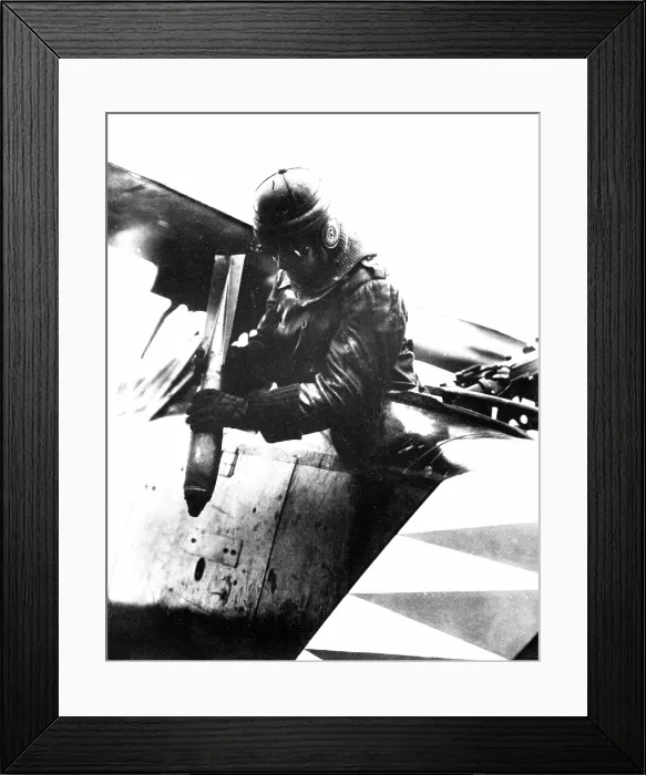 Framed Print : German World War I aviator dropping a bomb somewhere on the western front. 1914-1918