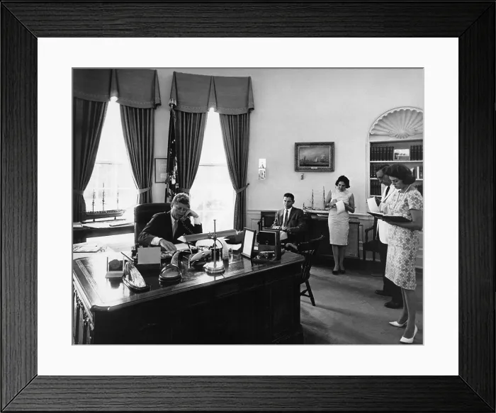 Framed Print : President John Kennedy addresses AMVETS Convention in New York City by telephone. Staff and reporters take notes as he speaks to the Veterans organization. Aug. 8, 1962