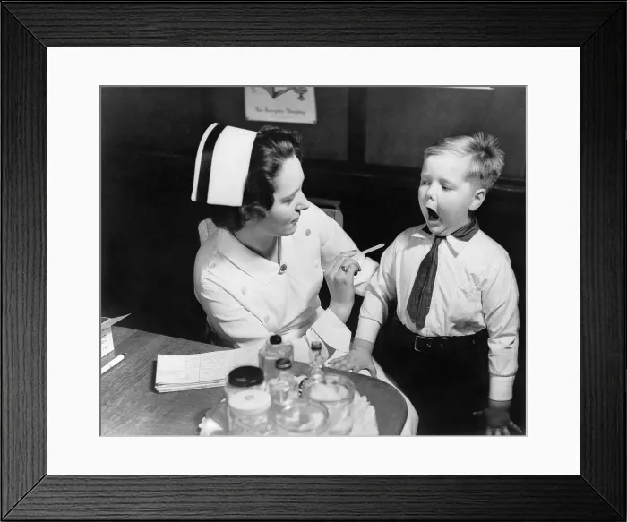 Framed Print : A nurse examining the teeth of a boy in New York, N.Y. ca. 1935
