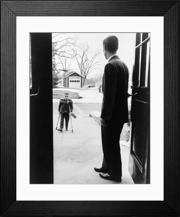 Framed Print : School principal, E. Joseph LaLiberte, waits for seven-year-old polio victim, Eddie Randolph in 1956