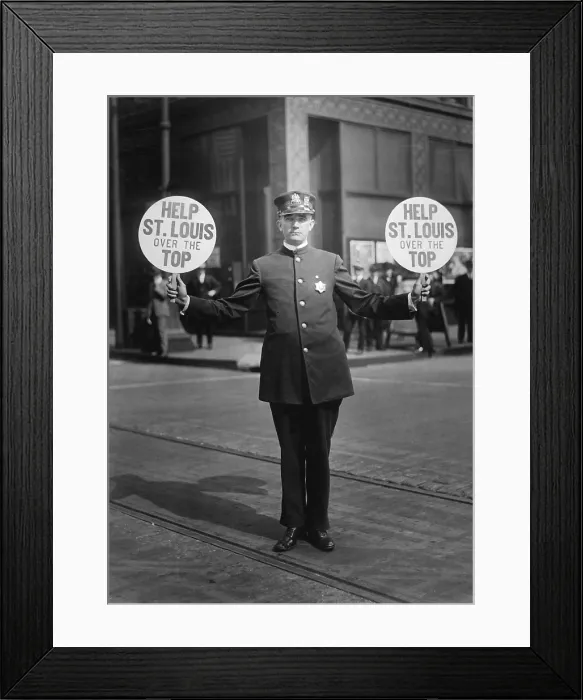 Framed Print : Fourth Liberty Loan Campaign during World War I. St. Louis traffic policeman using 4th Liberty Loan fans for signals. Fans read, Help St. Louis over the Top. 1918