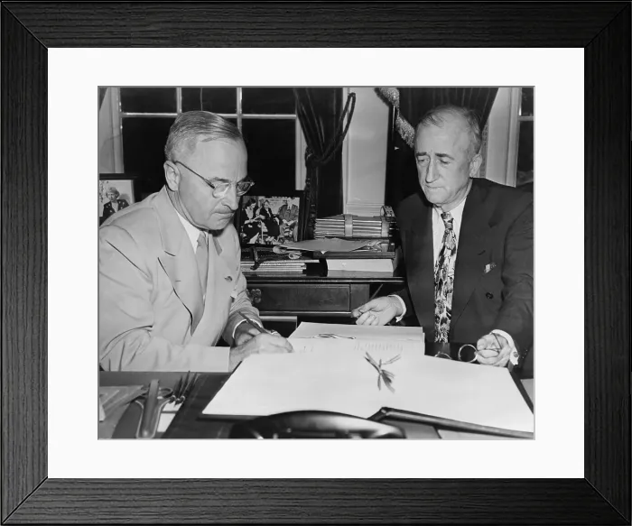 Framed Print : President Harry S. Truman, with Secretary of State, James F. Byrnes, signs the United Nations charter. 1945