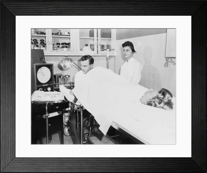 Framed Print : Doctor performs a Rubin test, at the infertility clinic at Long Island Jewish Hospital. The test detected fallopian tube blockages and is now replaced by laparoscopy. 1956