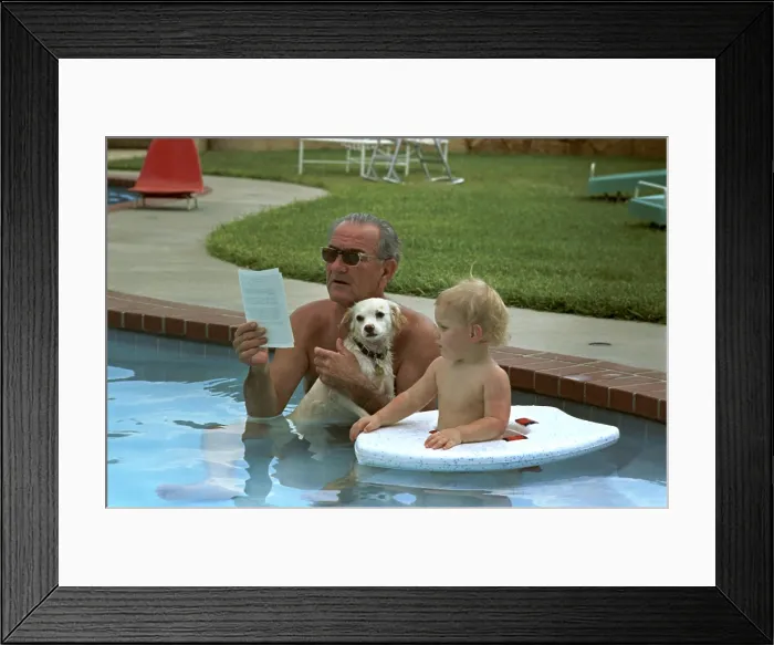 Framed Print : President Lyndon Johnson celebrates his 60th birthday in swimming pool with dog Yuki and grandson Patrick Nugent. Aug. 27, 1968