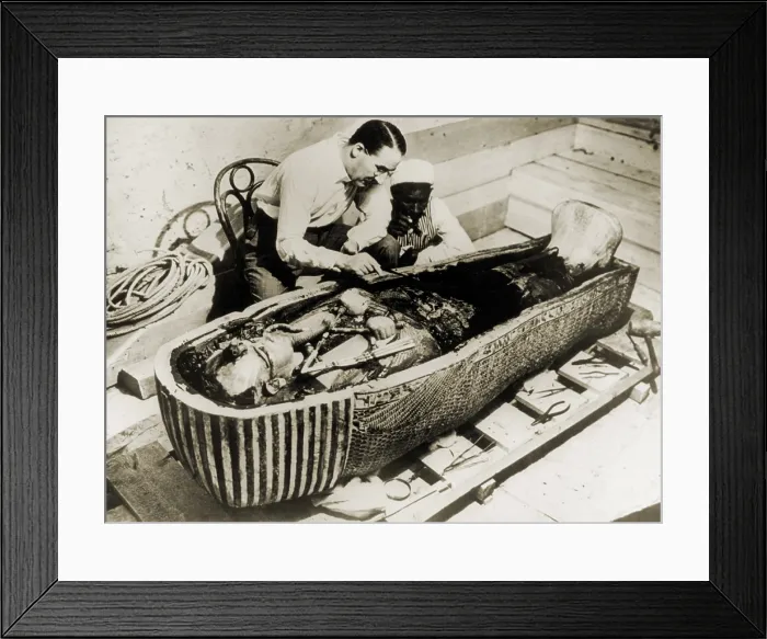 Framed Print : Howard Carter (1873-1939), seated beside coffin of King Tutankhamen, removing the consecration oils which covered the third or innermost coffin. 1926 Framed Print : Howard Carter (1873-1939), seated beside coffin of King Tutankhamen, removing the consecration oils which covered the third or innermost coffin. 1926