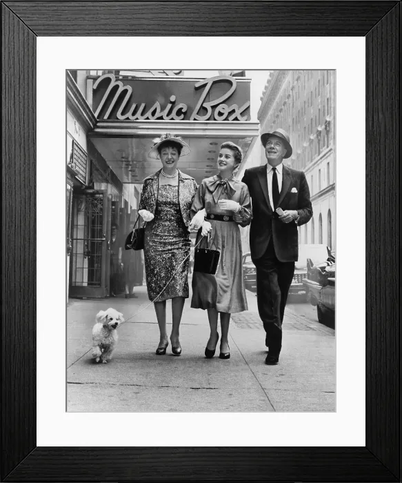 Framed Print : Cornelia Otis Skinner, Dolores Hart with dog on leash, and Cyril Ritchard, walking outside the Music Box theatre where they are starring in THE PLEASURE OF HIS COMPANY in 1959