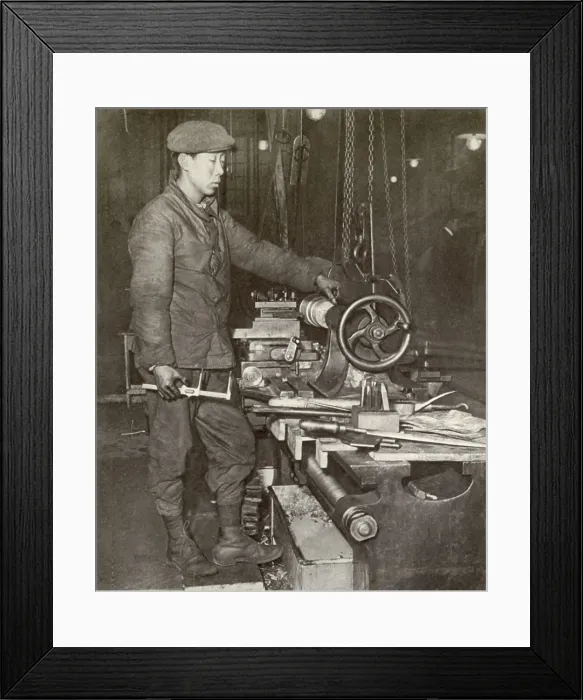 Framed Print : Indo-Chinese workman at ammunition factory lathe in France during WW1. 1916-17. The French colonies of Tonquin, Cochin, and Saigon offered a recruiting field for war workers