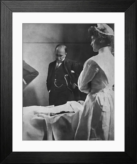 Framed Print : Sir William Osler (1849 - 1919), reading a patient's chart at bedside as a nurse watches Framed Print : Sir William Osler (1849 - 1919), reading a patient's chart at bedside as a nurse watches